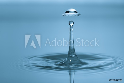 Picture of Water drop falling and drips on water mirror Water drop splash and make perfect circles on surface